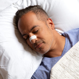 Sleeping man with nasal strip